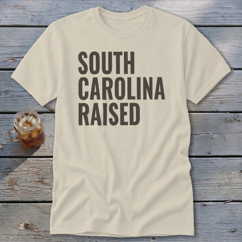 Tan t-shirt with "SOUTH CAROLINA RAISED" in dark gray text.
