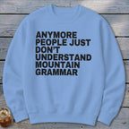 Light blue crewneck sweatshirt with black text reading "Anymore people just don't understand mountain grammar."