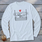 Couple and dog on swing, with mountains and red heart graphic.