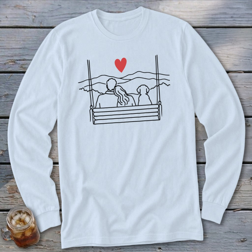 Couple and dog on swing, with mountains and red heart graphic.