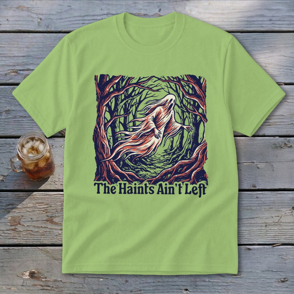 Light green t-shirt with ghost in forest graphic and text "The Haints Ain't Left".