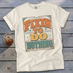Cream t-shirt with "Fixin' To Do Nothing" text in vintage style lettering.