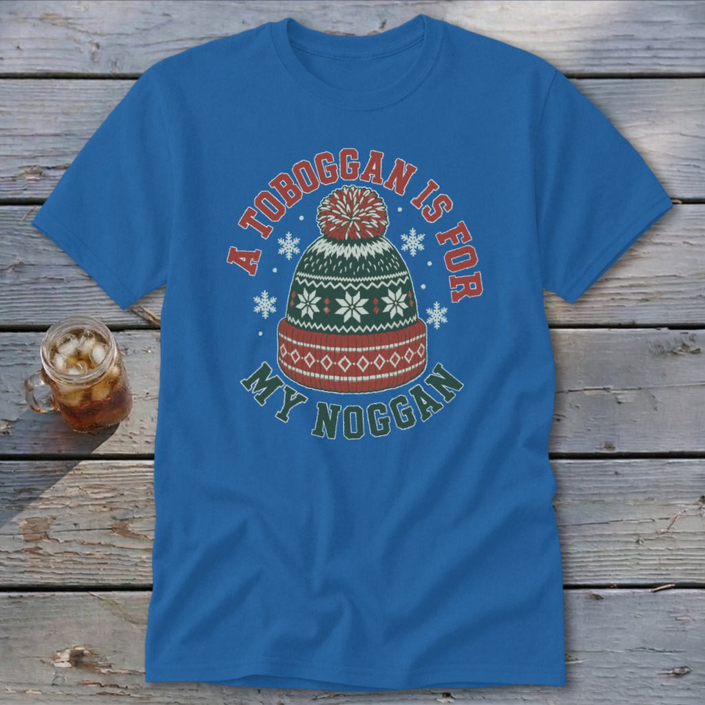 A blue t-shirt featuring a graphic of a winter hat with text reading A TOBOGGAN IS FOR MY NOGGAN.