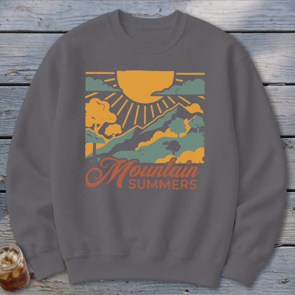 Graphic sweatshirt with "Mountain Summers" text and mountain landscape design.