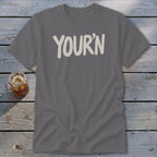 Gray t-shirt with "YOUR'N" text in cream white.