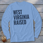 Light blue long sleeve t-shirt with dark blue text "WEST VIRGINIA RAISED".