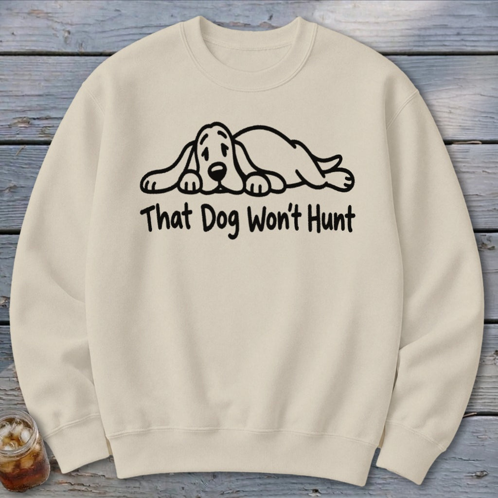 Beige crewneck sweatshirt featuring a black graphic of a sleeping hound dog and the text That Dog Won't Hunt.