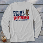 White long-sleeve shirt with "Plumb Tucker Out" and rocking chair graphic.