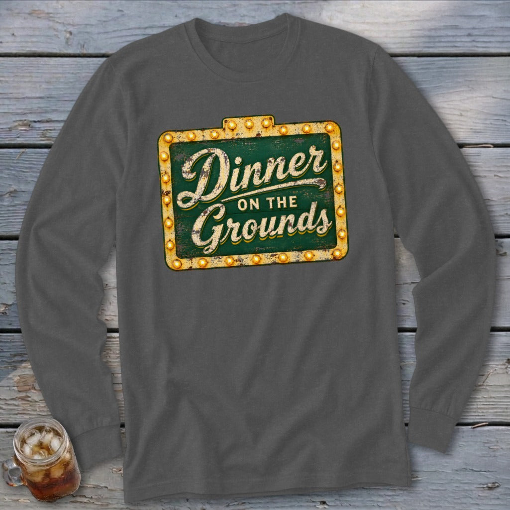 Dark gray long-sleeve t-shirt featuring a green vintage sign graphic that reads Dinner on the Grounds.