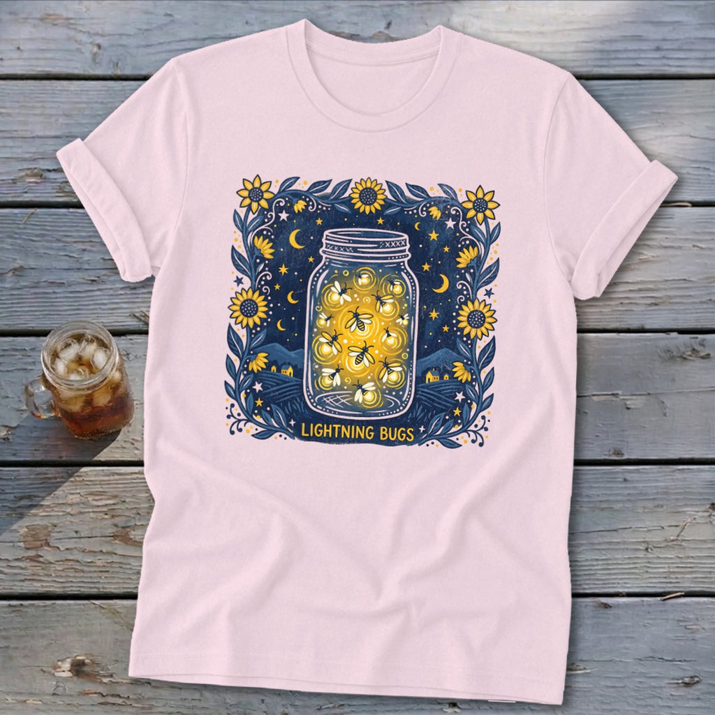 Pink t-shirt featuring a jar filled with lightning bugs against a starry night sky.