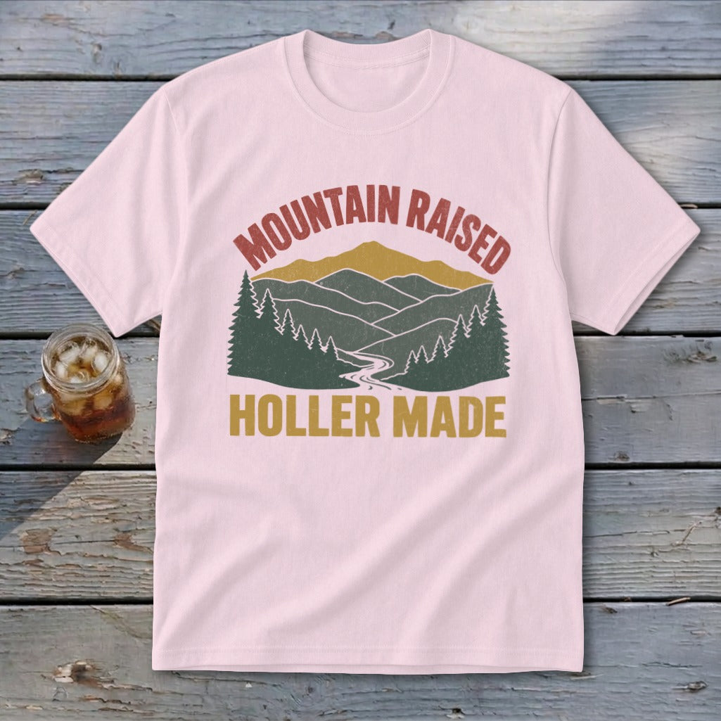 Light pink t-shirt with retro mountain landscape graphic and text reading MOUNTAIN RAISED HOLLER MADE.