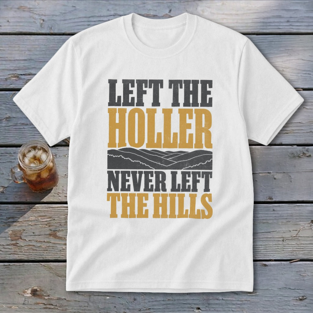 White t-shirt with text "Left the Holler Never Left the Hills" and mountain graphic.