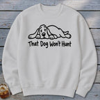 Light gray crewneck sweatshirt featuring a black graphic of a sleeping hound dog and the text That Dog Won't Hunt.