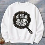 White crewneck sweatshirt with "No Sugar In The Cornbread" text in a skillet graphic.