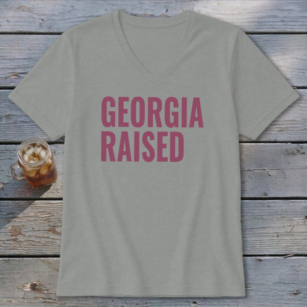 Grey v-neck t-shirt with pink "GEORGIA RAISED" text.