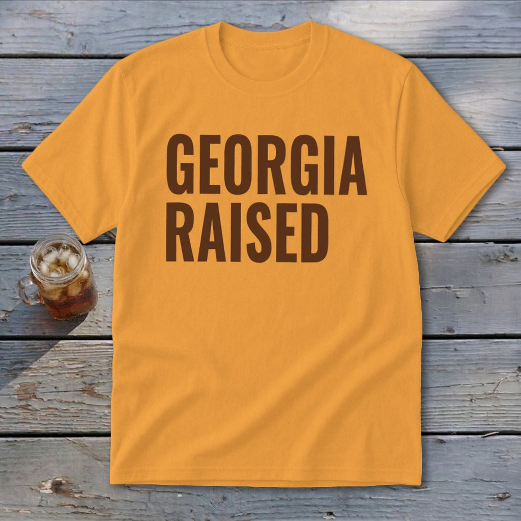 Orange t-shirt with "GEORGIA RAISED" text in dark brown font.
