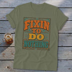 Green t-shirt with "Fixin to Do Nothing" text in orange, yellow, and teal lettering.