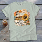 Light blue t-shirt with "Small Town Fall Vibes" graphic featuring a water tower and sunflower.