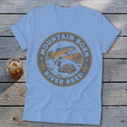 Light blue t-shirt with circular fishing graphic reading "Mountain Born River Bred".