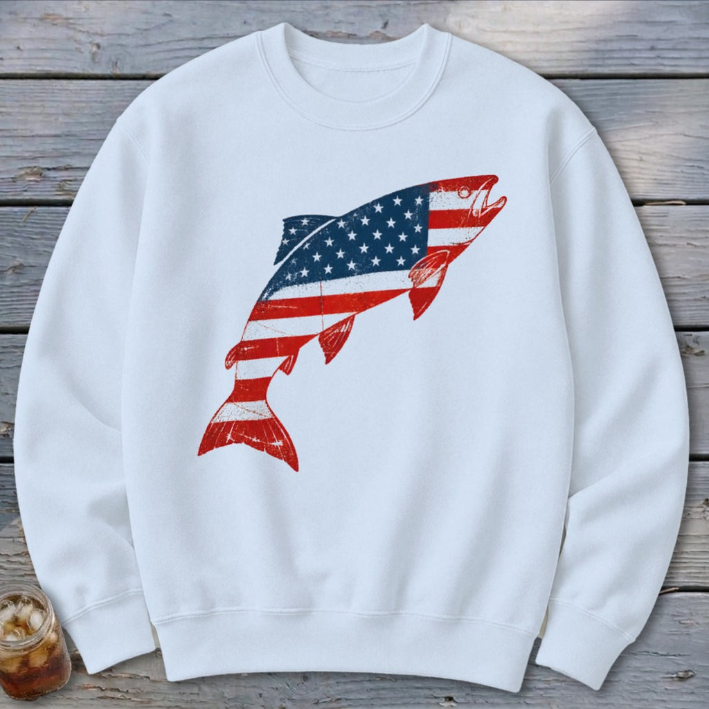 White crewneck sweatshirt featuring a distressed American flag graphic shaped like a leaping trout.