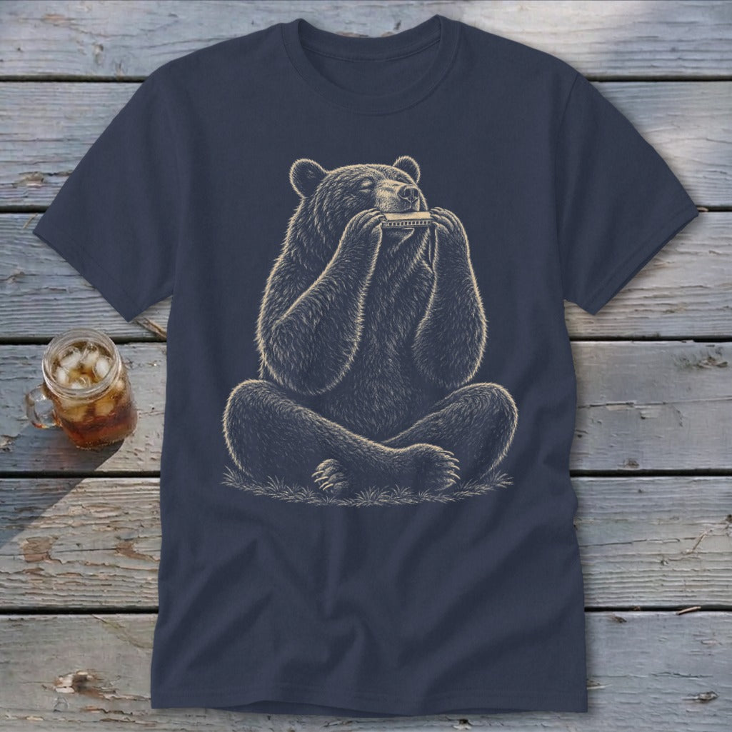 Bear sitting cross-legged playing a harmonica on a navy blue t-shirt.