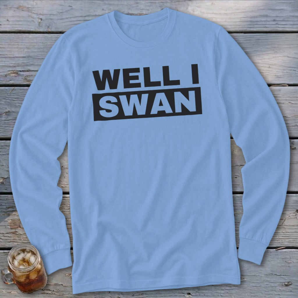A light blue long-sleeve t-shirt with the black text WELL I SWAN printed on the chest.