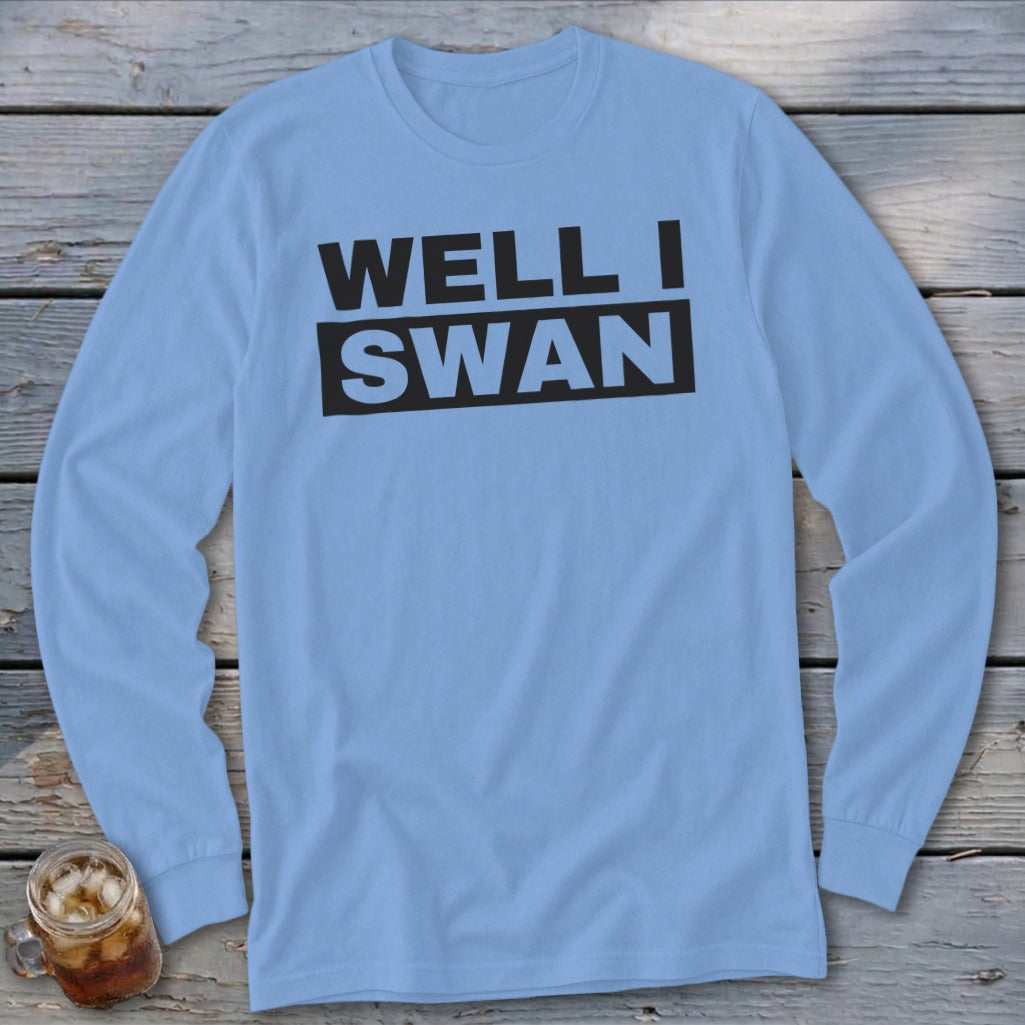 A light blue long-sleeve t-shirt with the black text WELL I SWAN printed on the chest.