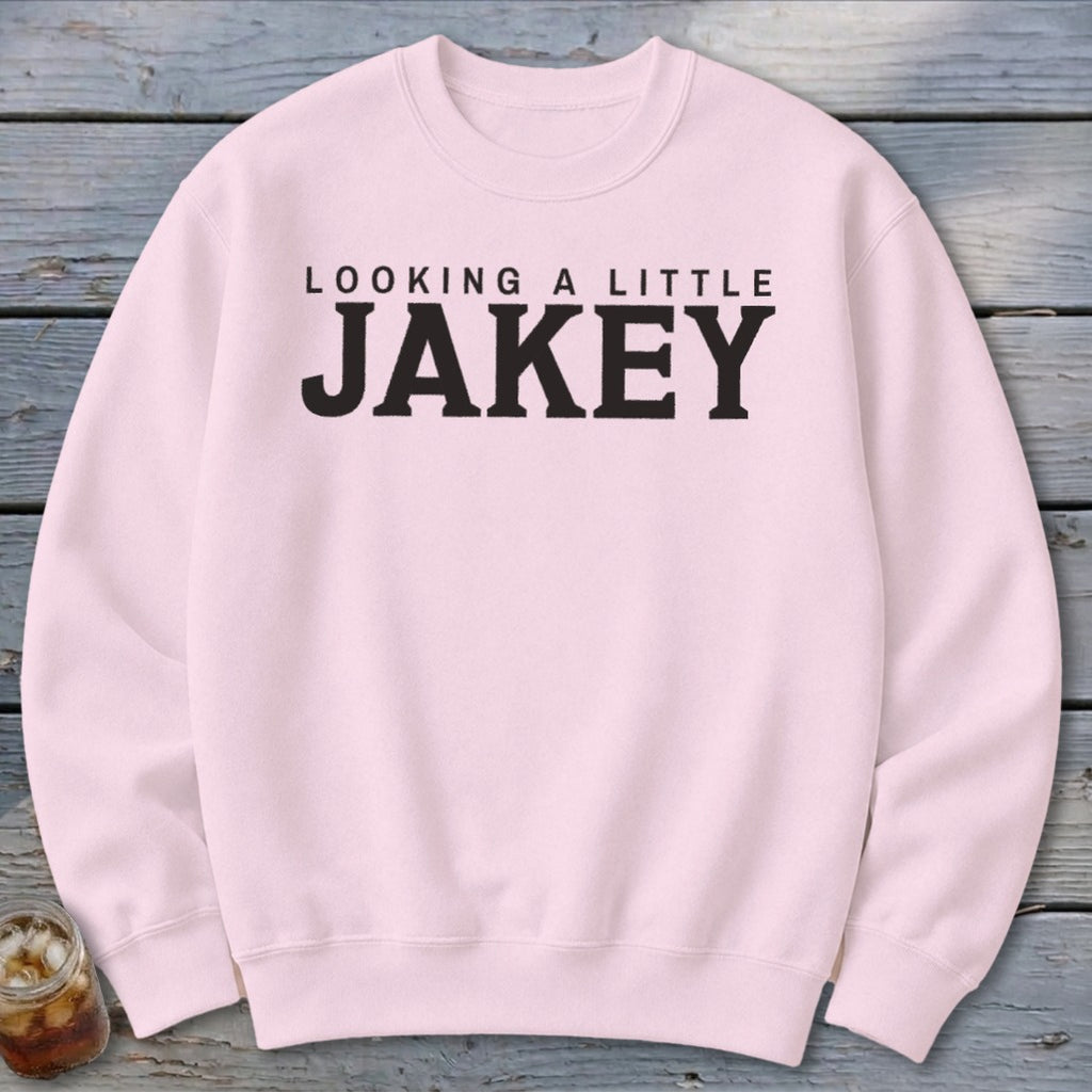 Pink crewneck sweatshirt with black text reading "LOOKING A LITTLE JAKEY".
