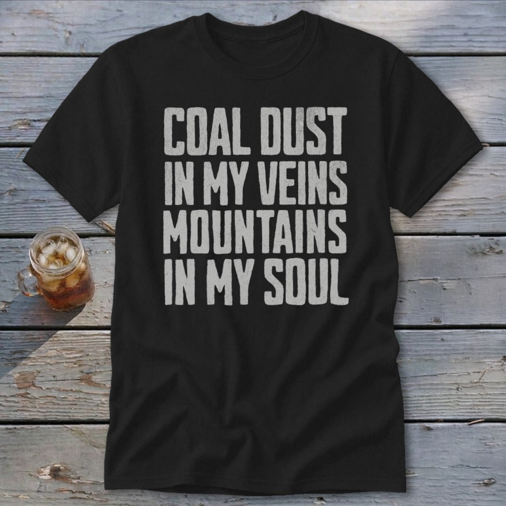 A black t-shirt printed with the white distressed text Coal Dust in My Veins Mountains in My Soul.