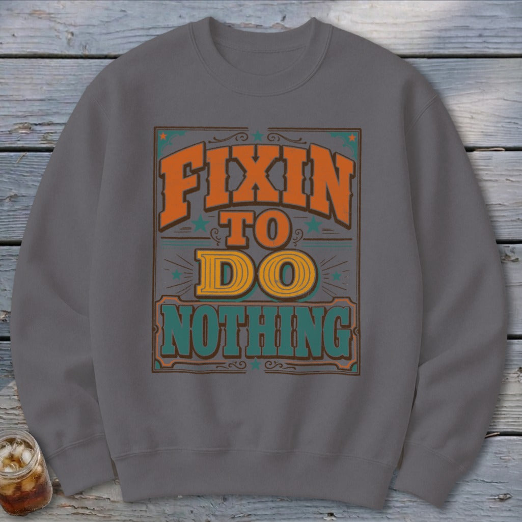 Gray sweatshirt with "Fixin' to Do Nothing" text graphic.