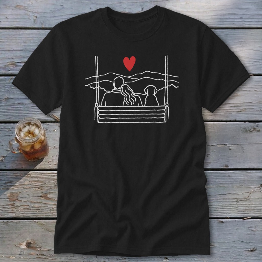 Black t-shirt with white line art of couple and dog on swing under red heart.