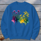 Blue sweatshirt with watercolor purple and yellow flowers and colorful ink splashes.