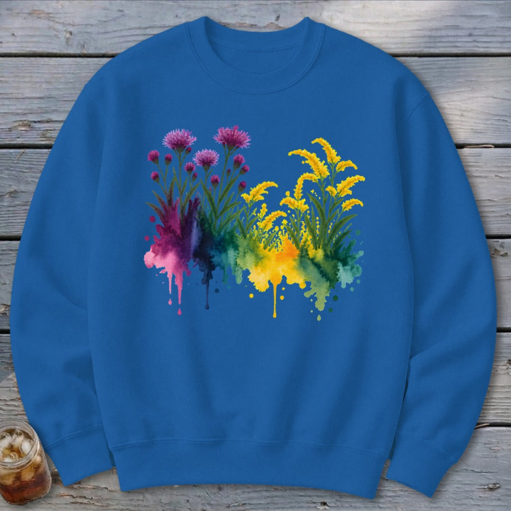 Blue sweatshirt with watercolor purple and yellow flowers and colorful ink splashes.