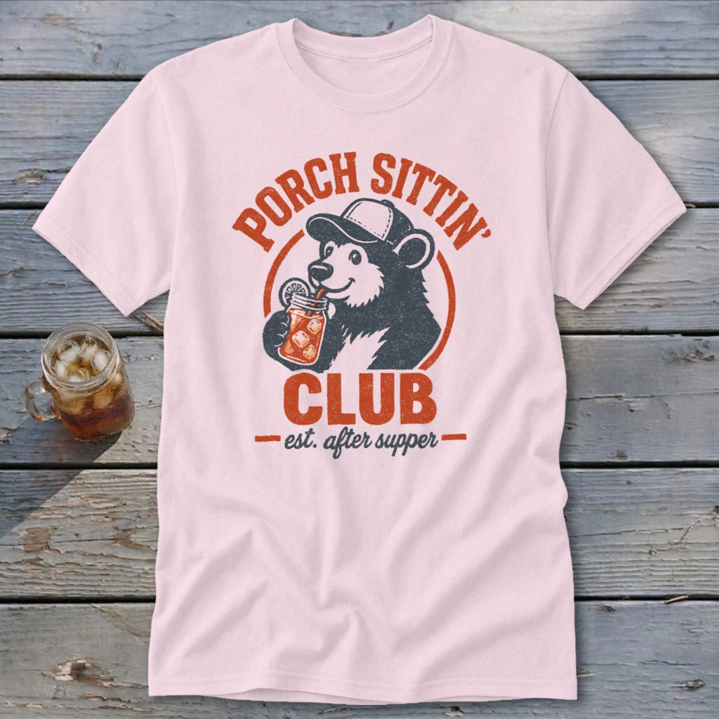 Pink t-shirt with a bear wearing a hat drinking from a jar, text "Porch Sittin' Club est. after supper".