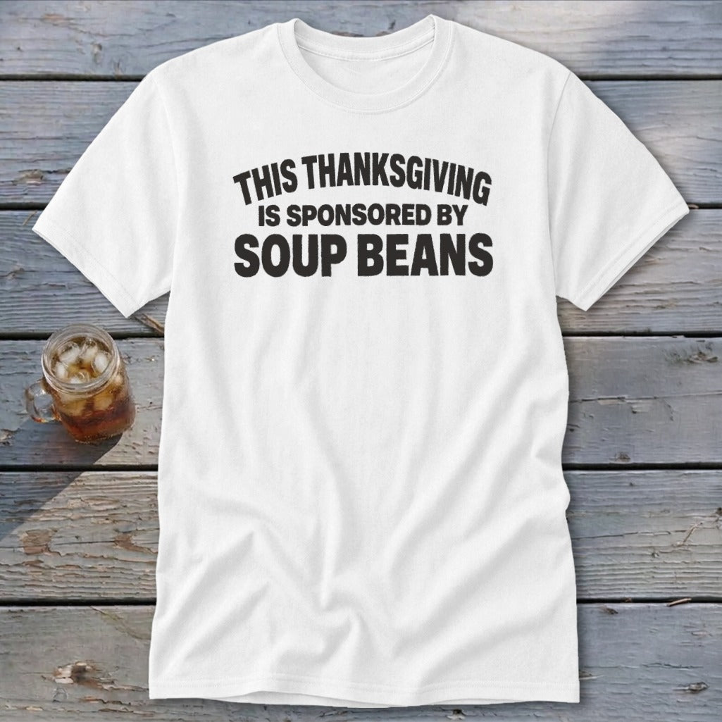 A white crewneck t-shirt with black text reading "THIS THANKSGIVING IS SPONSORED BY SOUP BEANS."