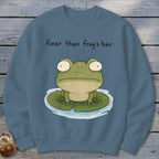 A blue sweatshirt with a graphic of a green frog on a lily pad and the text "finer than frog's hair".