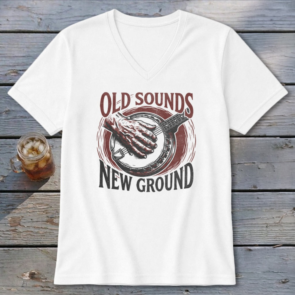 A white v-neck t-shirt featuring a banjo graphic and text that reads Old Sounds New Ground.