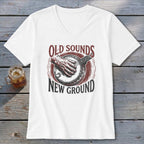 A white v-neck t-shirt featuring a banjo graphic and text that reads Old Sounds New Ground.