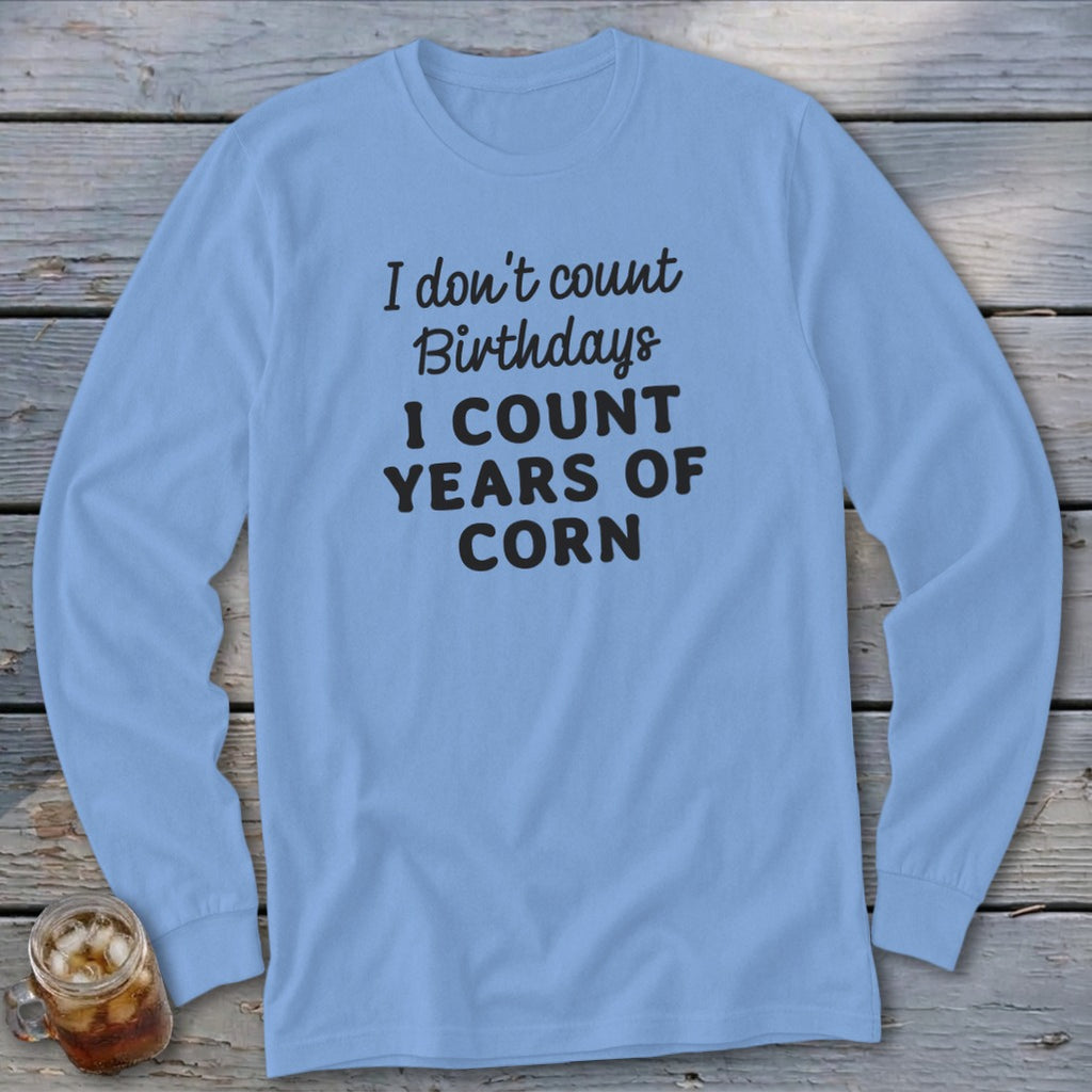 Light blue long-sleeve shirt with "I don't count birthdays I count years of corn" text.