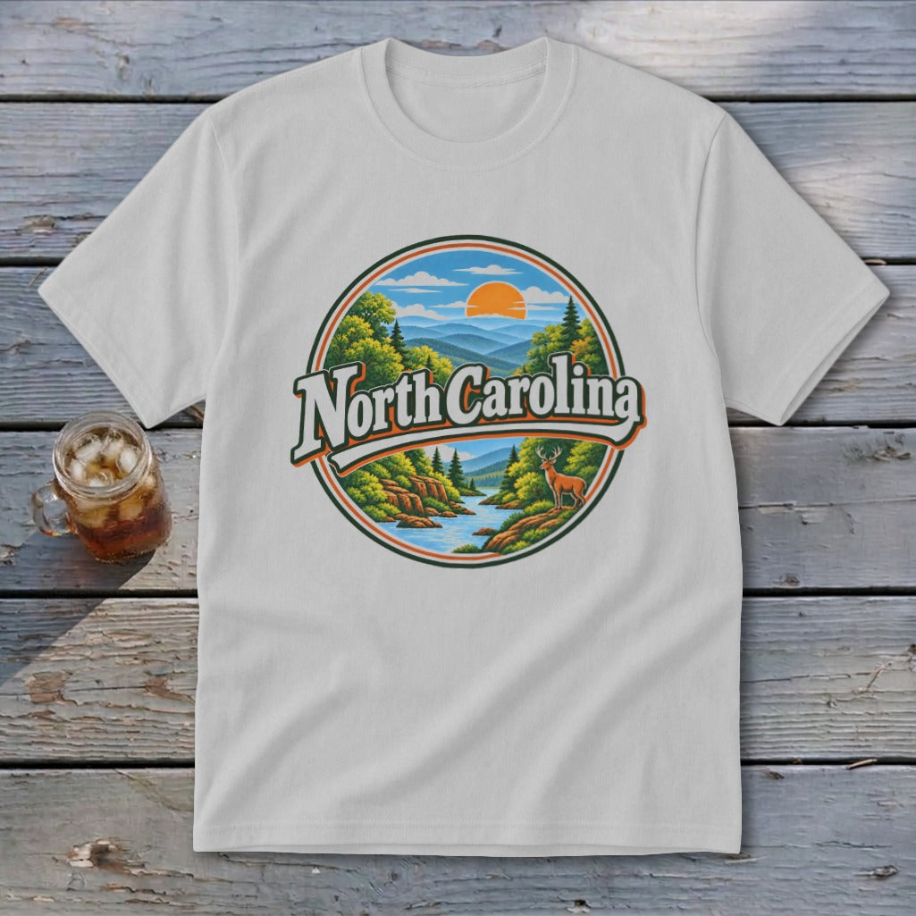 White t-shirt with a circular graphic of North Carolina mountains, river, deer, and sun.