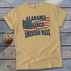 Yellow t-shirt with "ALABAMA RAISED AMERICAN MADE" and distressed US flag graphic.