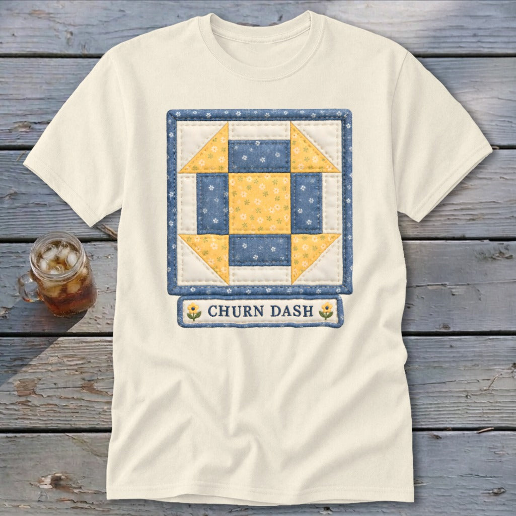 Cream t-shirt with a blue and yellow Churn Dash quilt block design.