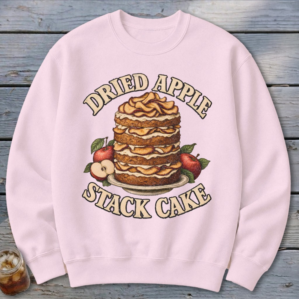 Pink sweatshirt with a dried apple stack cake and text graphic.