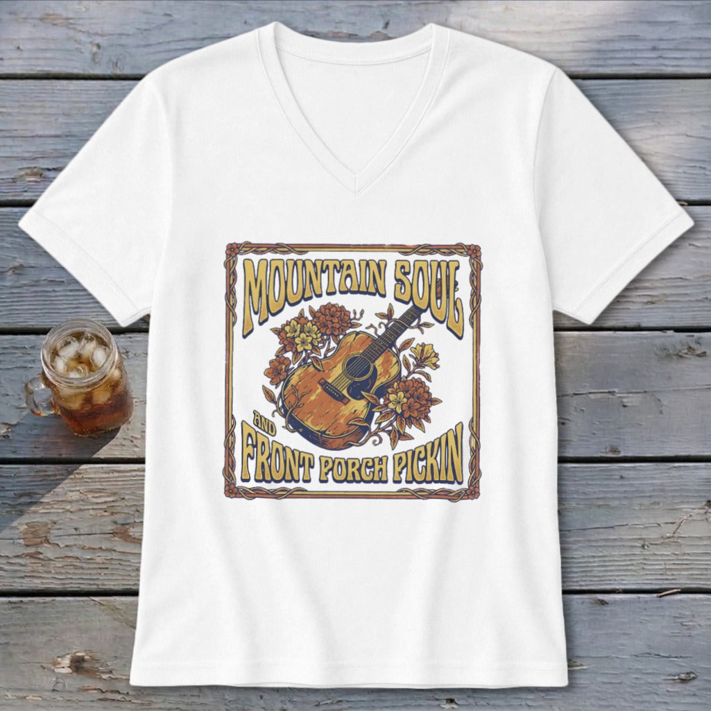 White t-shirt with a graphic featuring a guitar, flowers, and text "MOUNTAIN SOUL AND FRONT PORCH PICKIN'".