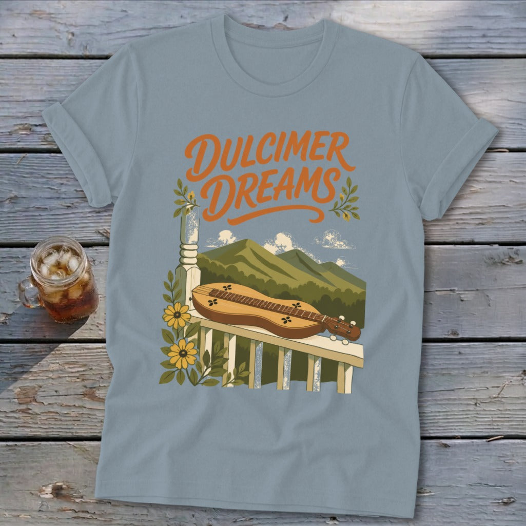 Light blue t-shirt with "Dulcimer Dreams" text, dulcimer on porch railing, and mountains.