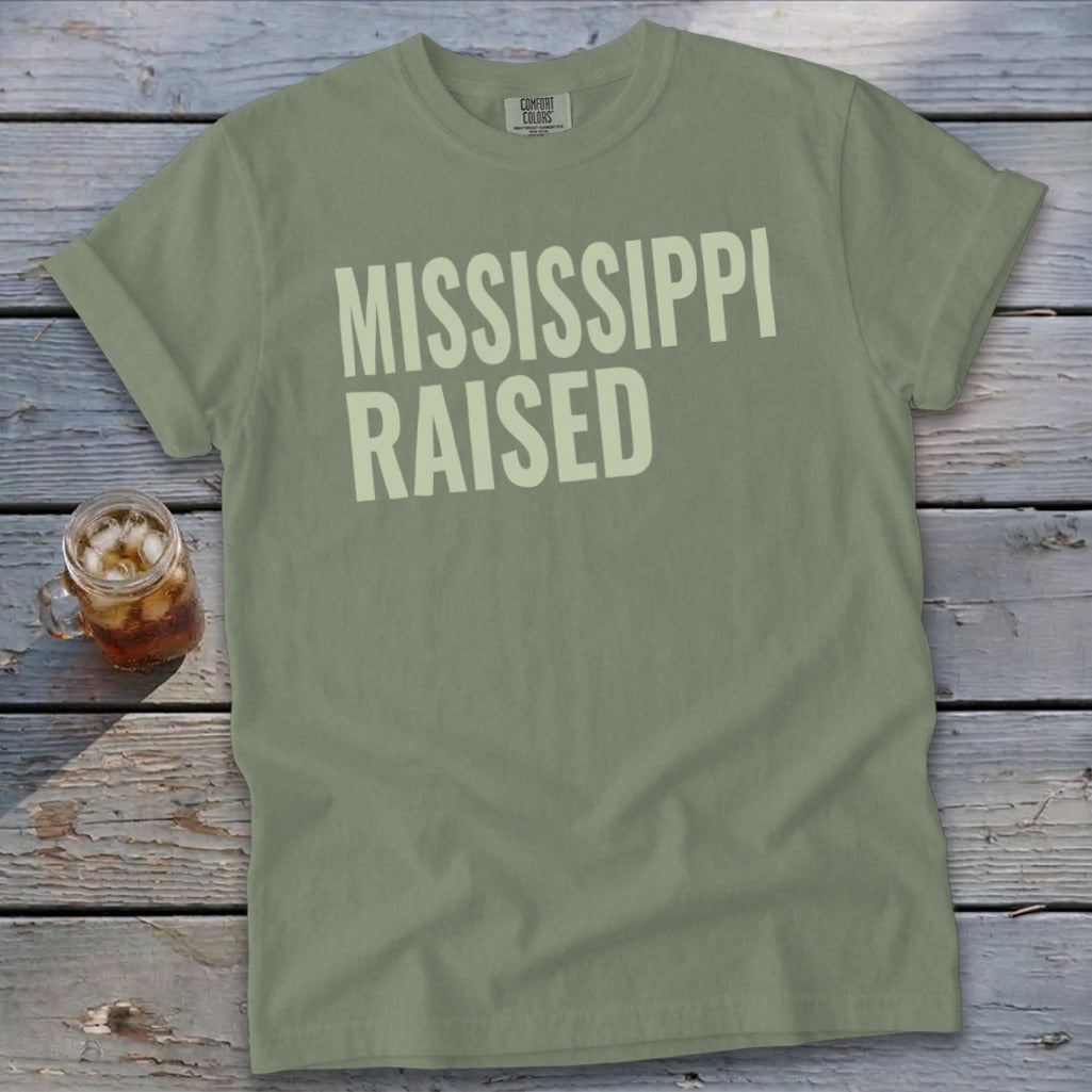 Olive green t-shirt with "MISSISSIPPI RAISED" in cream text.