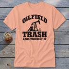 Peach t-shirt with black text and oil derrick graphic: "Oilfield Trash And Proud Of It."