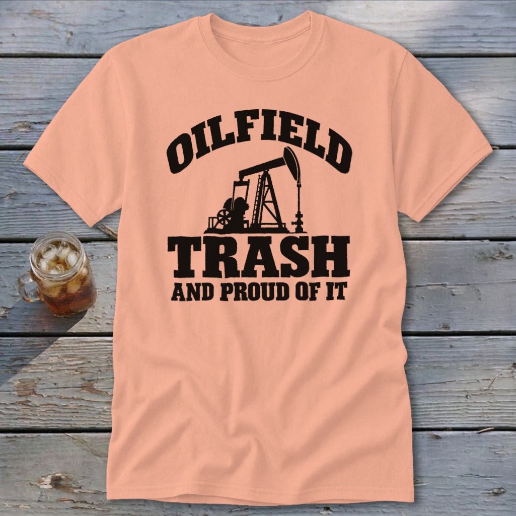 Peach t-shirt with black text and oil derrick graphic: "Oilfield Trash And Proud Of It."