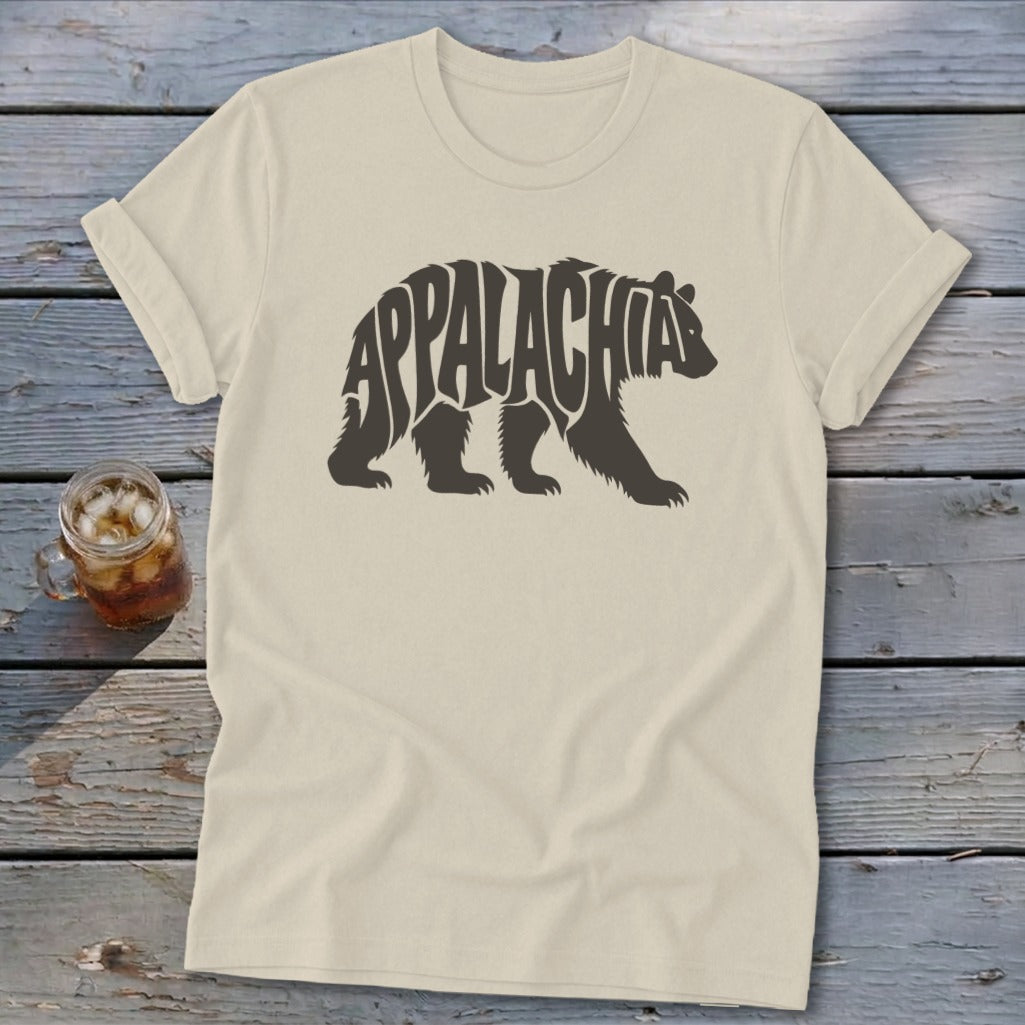 A cream-colored t-shirt with a dark brown graphic of a walking bear containing the text Appalachia.