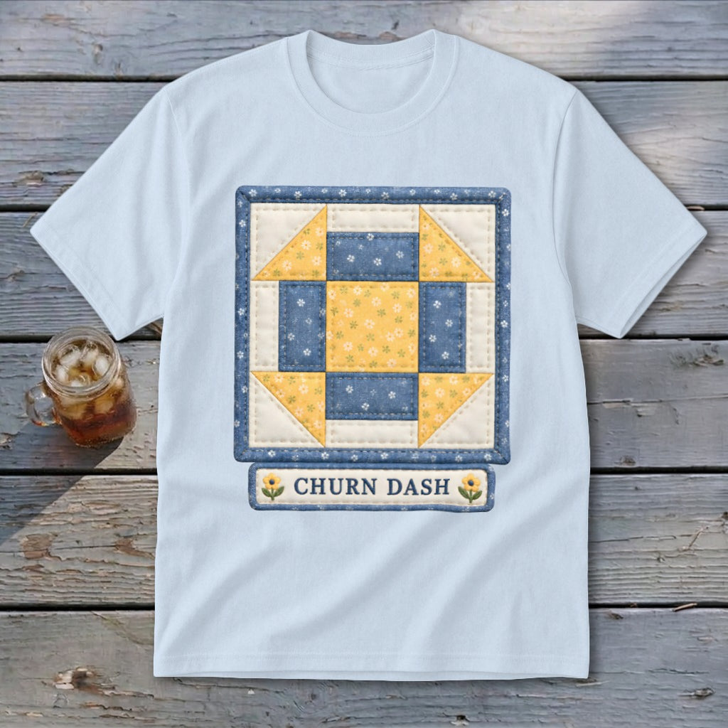 Light blue t-shirt with a square quilt block design reading "CHURN DASH".